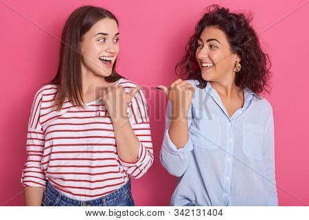 Indoor Shot Of Two Young Beautiful Girls Pointing Towards Each Other, Brunette Women Dress Shirts, S
