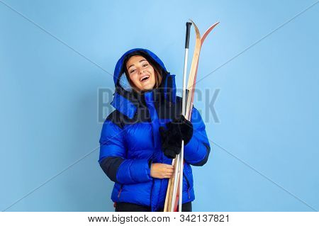 Skii Lover. Caucasian Womans Portrait On Blue Studio Background. Beautiful Female Model In Warm Clot