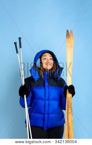 Skii Lover. Caucasian Womans Portrait On Blue Studio Background. Beautiful Female Model In Warm Clot