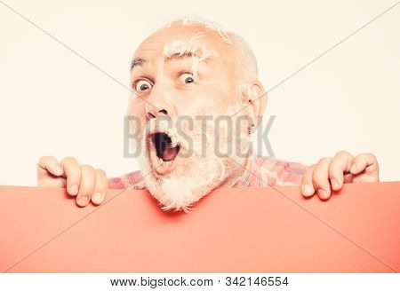 Feathers Madness. Man Bearded Mature Emotional Face With Stuck White Feathers Close Up. Funny Pensio