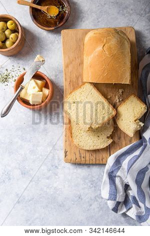 Fresh Homemade Crisp Bread  And Slices With Olive Oil, Butter And Green Olives, Top View.  Baking Co