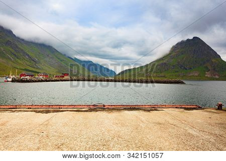 Fjord Coast Landscape. Typical Norwegian Fishing Village With Traditional Red Rorbu Huts, Ramberg, L
