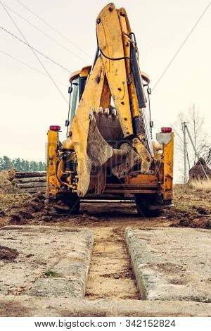 The Excavator Installs Concrete Slabs For The Road.