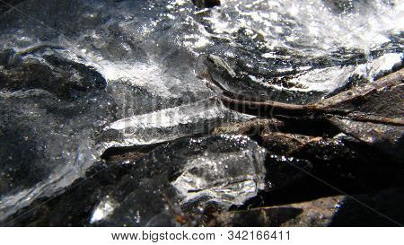 Rocks Covered In Ice With Air Bubbles Inclosed In Sunlight