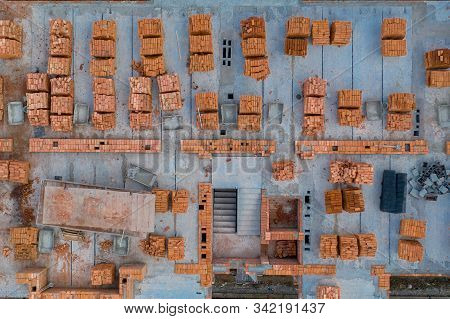 Pallets Of Clay Brick Stored For Building Construction. Construction Site Background. Top View, Ndus