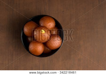 Indian Dessert Or Sweet Dish : Gulab Jamun In Bowl On Wooden Background.