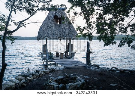 Small Dock With Palm Leaf Roof At Lake Salpeten After Sunset, Near El Remate, Peten, Guatemala