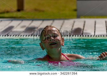 Troia, Portugal - June 2018. Girl Playing In The Swimming Pool