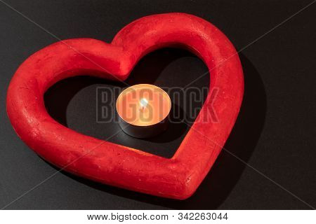 Paper Heart And Candle On A Black Background. Valentines Day.