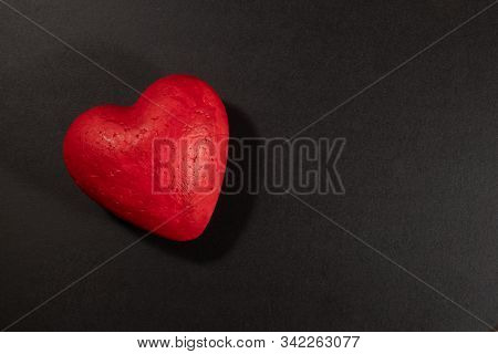 Grunge Red Paper Heart On A Black Background