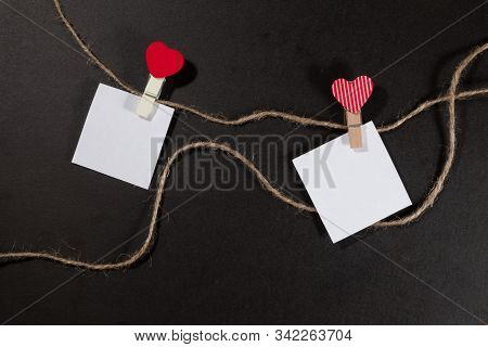 Two Paper Stickers Attached With Clothespins On A Rope And Hand Made Heart Makes. Valentines Day Bla