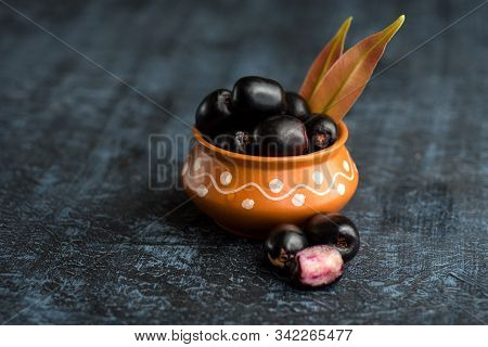 Jambolan Plum Or Jambul Or Jamun Fruit, Java Plum (syzygium Cumini) With Leaf On Stone Textured Back