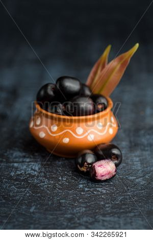 Jambolan Plum Or Jambul Or Jamun Fruit, Java Plum (syzygium Cumini) With Leaf On Stone Textured Back