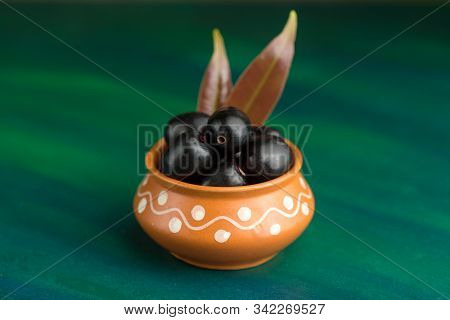 Jambolan Plum Or Jambul Or Jamun Fruit, Java Plum (syzygium Cumini) On Textured Background.