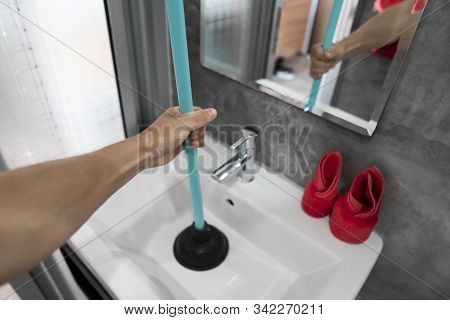 Sink Repair By Hand With A Toilet Plunger. Plumbing. A Plumber Uses A Plunger To Unclog A Sink. Toil