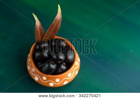 Jambolan Plum Or Jambul Or Jamun Fruit, Java Plum (syzygium Cumini) On Textured Background.