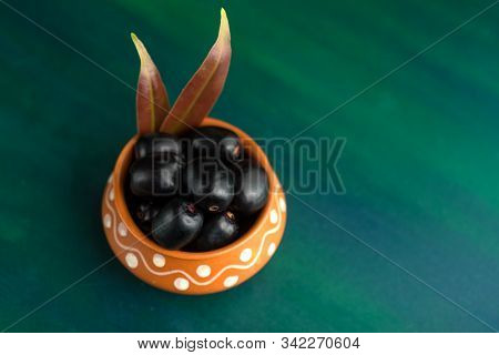Jambolan Plum Or Jambul Or Jamun Fruit, Java Plum (syzygium Cumini) On Textured Background.