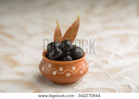Jambolan Plum Or Jambul Or Jamun Fruit, Java Plum (syzygium Cumini) With Leaf On Stone Textured Back