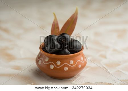 Jambolan Plum Or Jambul Or Jamun Fruit, Java Plum (syzygium Cumini) With Leaf On Stone Textured Back