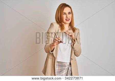 Redhead caucasian business woman standing over isolated background disgusted expression, displeased and fearful doing disgust face because aversion reaction. With hands raised. Annoying concept.