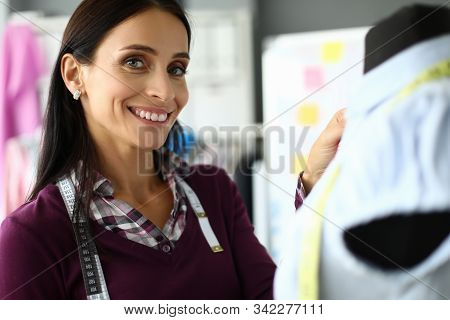 Close-up View Of Cheerful Smiling Seamstress Taking Measurement Of Blouse. Fashion Designer Making C