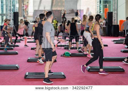 Rimini, Italy - May 2019: Fitness Workout In Gym: People Doing Exercises In Class With Step Platform