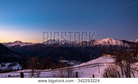 Sunset In The Mountains Between Slovenia And Italy In A Freezing Winter Day