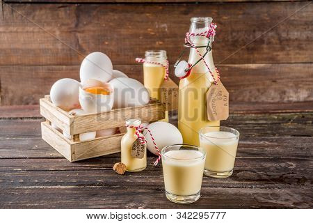 Traditional Italian Vov Eggs Liquor. German Egg Liqueur Eierlikor. In Different Bottle And Shot Glas