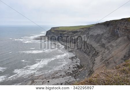 Sand And Rock Sea Cliffs Eroding In Yorkshire England.