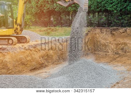 Excavator Digging Bucket Scooping Gravel From In The Building Foundation