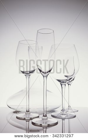 Glassware Selection With Wine, Champagne, Liquour Glasses And Decanter On The Light Background.. Fin