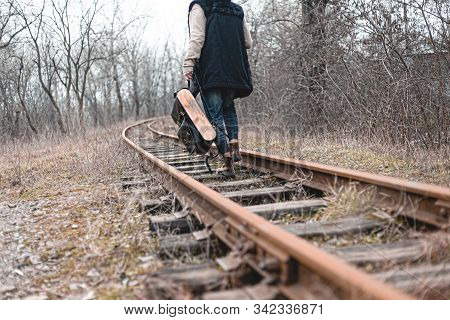 A Guy In Suede Autumn Boots On The Railway. The Concept Of Hiking, Travel Practical Clothes, Shoes.