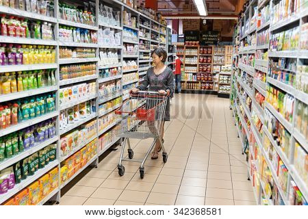 Series Of Asian Woman Shopping Groceries In Modern Supermarket.