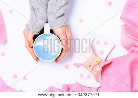 Female Hands Holding Cup Of Vegan Blue Latte. Gift Alike Dessert With Heart Shape Sprinkles. Valenti