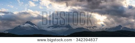 Striking And Dramatic Panoramic Canadian Landscape View Of The Mountain Peaks During A Cloudy Sunset