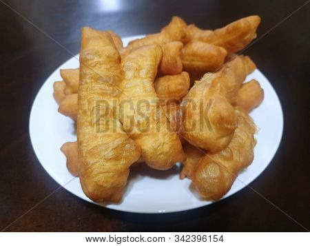 Top View Of Padnoongo In White Plate Isolated On Wooden Background, Ready To Eat Or Serve, Fried Foo