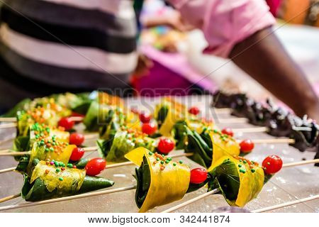 Cone Of Mango Flavored Betel Leaf Stuffed With Cherry Known As Mango Paan.