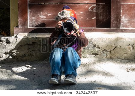 Young Boy Playing With Camera