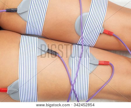 The Procedure Of Myostimulation On The Legs And Buttocks Of A Woman In A Beauty Salon. Overweight Tr