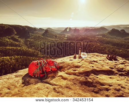Red Backpack And Prepared Healthy Food Picnic In Pure Nature. Sandstone Cliff With Sandwiches , Frui