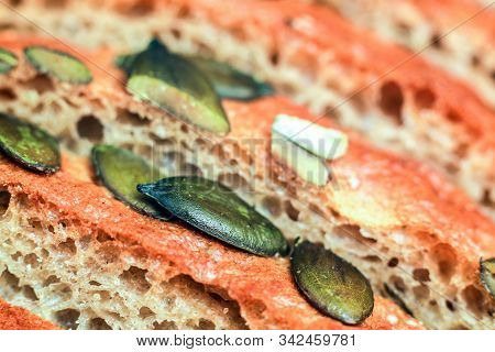Close-up On Pre-sliced Rye And Wheat Bread With Pumpkin Seeds On Top