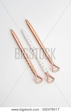 Three Designer Ball Point Pens Isolated On A Light Background, Set In A Diagonal Orientation.  Two P