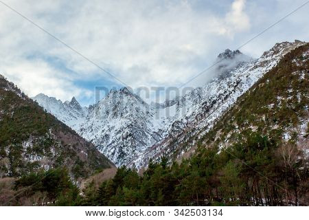 Snow Covered Mountain Range. View From The Valley.