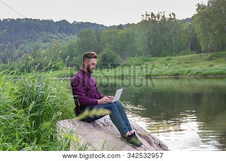Workaholic Man Working On Laptop During Vacation, Remote Work, View From Back. Freelancer.