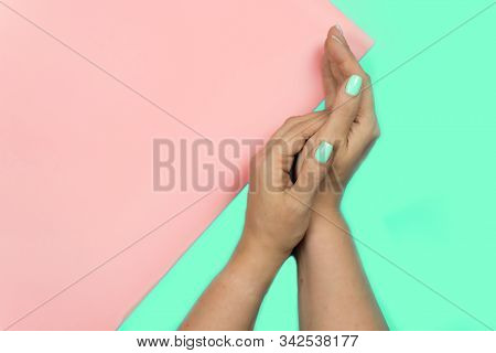 Stylish Trendy Female Blue New Manicure. Beautiful Young Womans Hands On Pink And Blue Background. A