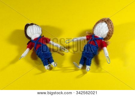 Handmade Crochet Doll Toys On Yellow Background. Amigurumi Doll.