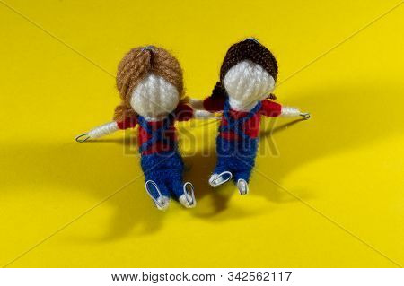 Handmade Crochet Doll Toys On Yellow Background. Amigurumi Doll.