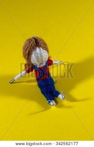 Handmade Crochet Doll Toys On Yellow Background. Amigurumi Doll.