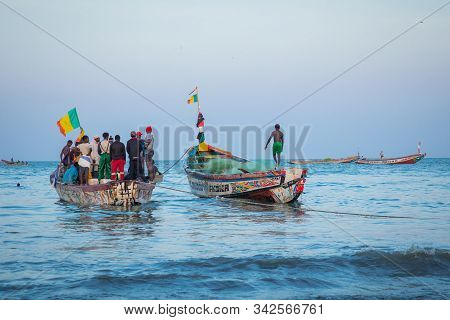 Tanji, The Gambia - November 21, 2019: Scene With Men And Women Carrying Fish From The Boats To The