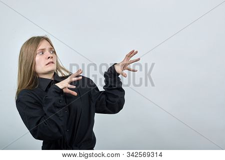 Disappointed Young Woman In Fashion Black Shirt Isolated On Gray Background In Studio Spreads Hands 